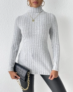 Detail of light gray turtleneck sweater with vertical ribbed texture and slim fit design