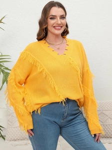 Detail of yellow V-neck knit sweater featuring stylish fringe accents and distressed edges