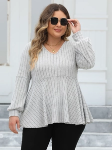 Detail shot of the ribbed knit fabric and V-neckline on the grey plus size peplum top