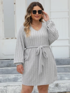 Detail of light grey V-neck ribbed knit dress featuring a matching adjustable drawstring waist