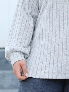 Close-up of light grey ribbed knit long sleeve top with lantern sleeve and ribbed cuffs