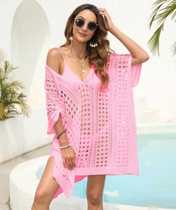 Detailed close-up of hot pink hollow-out crochet beach cover-up with stylish side slits