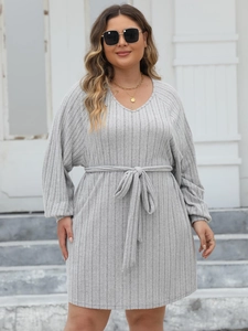 Close-up of ribbed grey knit dress featuring a V-neckline and drawstring waist tie detail