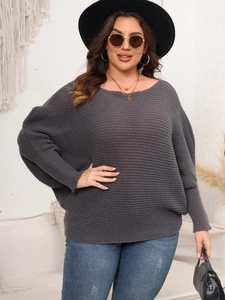 Detail of dark grey knit sweater with batwing sleeves and ribbed texture design