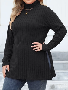 Detail of black turtleneck knit tunic with vertical ribbed texture and high side slits