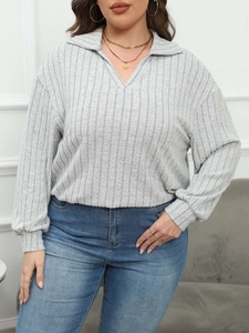 Detail of light grey plus size ribbed knit polo top featuring a V-neckline and long sleeves