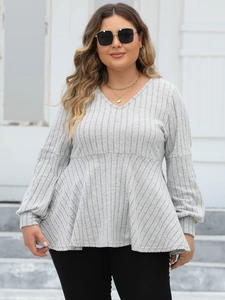 Detail of grey V-neck peplum top in ribbed knit fabric with long lantern sleeves