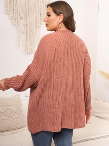 Detail of chunky knit texture on a dusty pink oversized cardigan with drop shoulder design