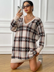 Detail shot of distressed oversized V-neck knit sweater dress with plaid pattern