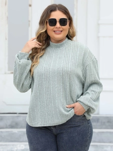 Detail of grey-green ribbed knit texture on a plus size mock neck pullover sweater