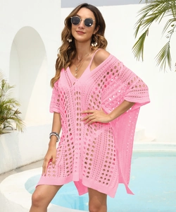 Close-up detail of pink crochet knit beach cover-up with hollow diamond mesh texture