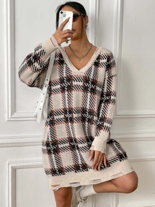 Close-up of V-neck plaid knit sweater dress with distressed hem and vintage checkered pattern