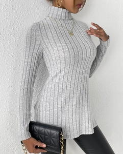 Detail of grey ribbed turtleneck sweater featuring vertical knit texture and slim fit