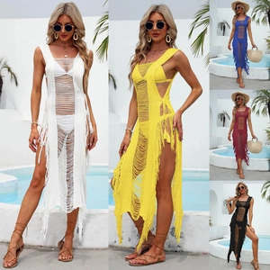 Detail of crochet beach cover-up featuring ladder cut-outs and bohemian fringe hem