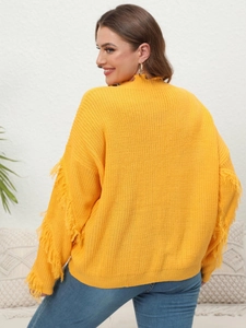 Back view of a yellow knitted sweater featuring fringe sleeves and distressed collar detail