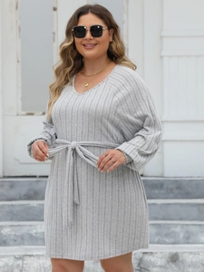 Detail of light grey ribbed knit dress featuring a v-neckline and waist tie belt