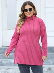 Detail of ribbed texture on long sleeve turtleneck tunic top in magenta pink