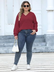 Women's V-neck ribbed long sleeve top in dark red paired with navy skinny jeans
