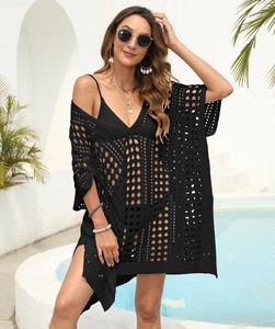 Detail of black hollow out crochet beach cover-up showing geometric knit and side slit