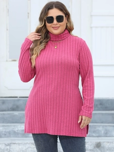 Close-up of rose red ribbed turtleneck tunic with high side slits and long sleeves