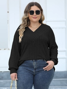 Women's plus size black V-neck ribbed long sleeve top paired with blue jeans