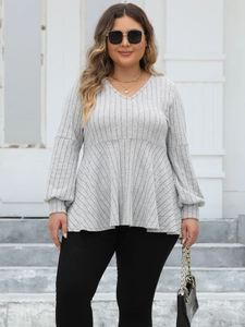 Detail of grey V-neck rib-knit top featuring elegant lantern sleeves and textured fabric
