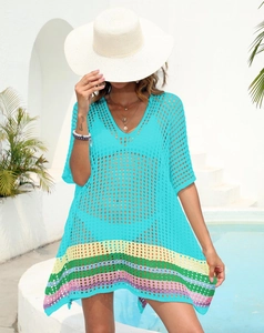 Detail of crochet knit beach cover-up with turquoise mesh and colorful striped hem