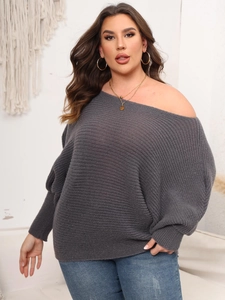 Detail of grey off-shoulder oversized knit sweater with wide batwing sleeves and ribbed texture