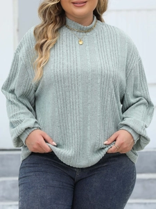 Close-up of mint green ribbed texture on this plus size mock neck long sleeve top