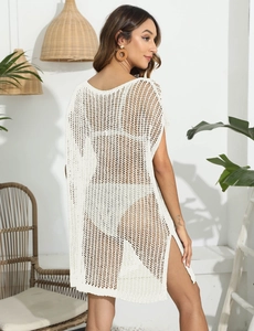 Detail of white crochet knit beach cover-up featuring side slits and hollow-out texture