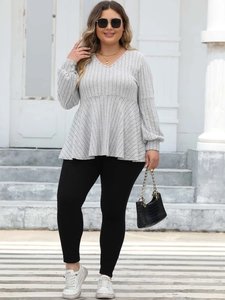 Close-up of gray V-neck ribbed top with lantern sleeves and peplum hem detail
