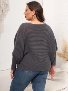 Rear view of women's oversized dark gray knit sweater with batwing sleeves and boat neck