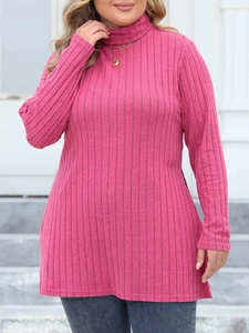Detail of rose pink high neck ribbed knit top with long sleeves on a model outdoors