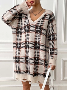 Detail of V-neck plaid knit dress featuring distressed frayed hems and soft texture