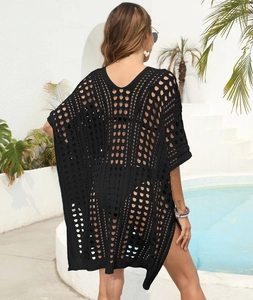 Detail of black openwork knit beach cover-up showing the intricate crochet texture