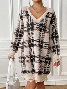 Detailed view of women's oversized V-neck plaid sweater dress with distressed hem and cuffs