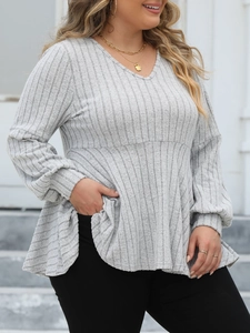 Detailed texture of grey ribbed fabric on a plus size V-neck peplum top with lantern sleeves