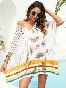 Detail of white crochet beach cover-up featuring rainbow stripes and V-neck hollow knit texture