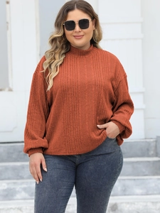 Women's plus size mock neck ribbed knit top in burnt orange with long lantern sleeves