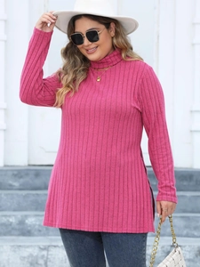 Detail of rose pink ribbed knit tunic featuring a high neck and side split hemline