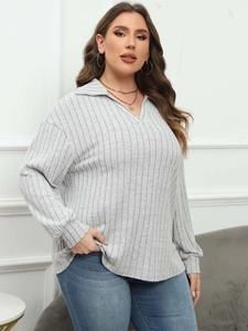 Detail of grey ribbed knit polo top with V-neckline and long sleeves for casual women style