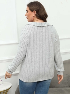 Close-up of light gray ribbed knit texture and drop shoulder design on a women's polo top