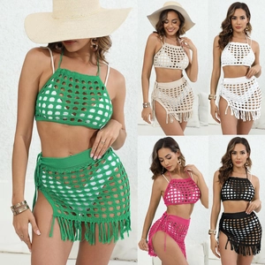 Detail of crochet two-piece beach set with hollow-out design and fringe tassels