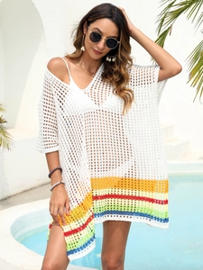 Close-up of white crochet beach cover-up with rainbow stripe hem and hollow knit details