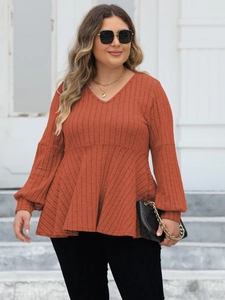 Women's plus size rust red V-neck knit top with lantern sleeves and a peplum hem