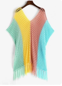 Detail of multi-color striped crochet beach cover-up featuring fringe hem and knit texture