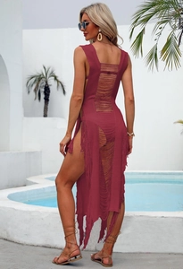 Detail of burgundy crochet beach cover-up featuring ladder back cut-outs and long fringe trim