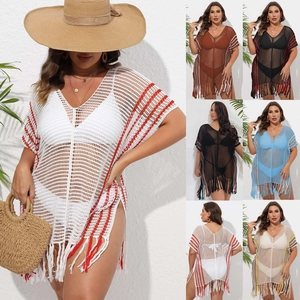 Detail of crochet beach cover-up with multi-color stripes, V-neck design and long fringe trim