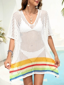 Detail of white crochet beach cover-up featuring colorful striped hem and V-neck design