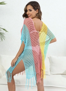 Detail of colorful crochet beach cover-up featuring open knit texture and tassel hem